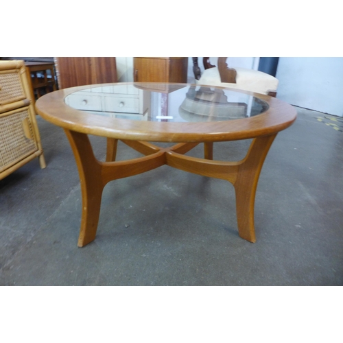 59 - A circular teak and glass topped coffee table