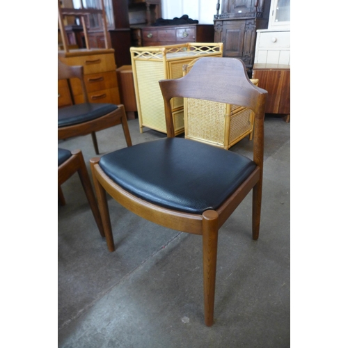 61 - A set of six Danish style teak and black vinyl dining chairs