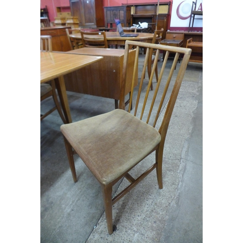 82 - A Vespa teak six piece dining suite comprising sideboard, an extending dining table and four chairs