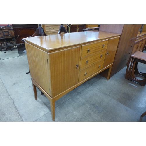 82 - A Vespa teak six piece dining suite comprising sideboard, an extending dining table and four chairs