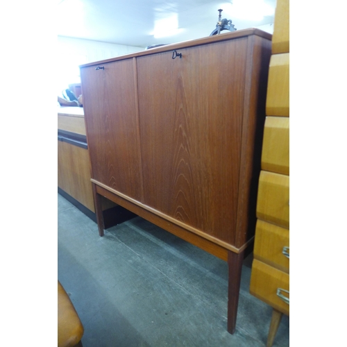 83 - A teak two door record cabinet