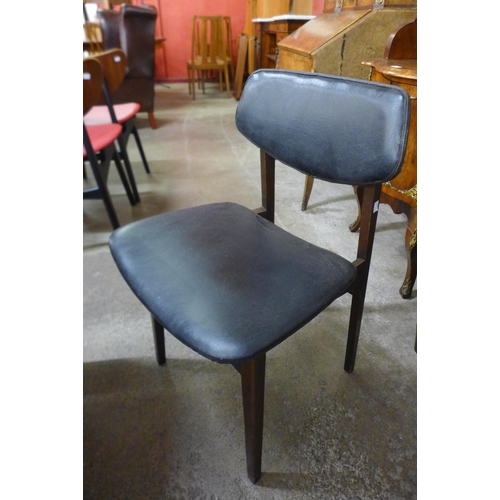 94 - A set of four teak and black vinyl dining chairs