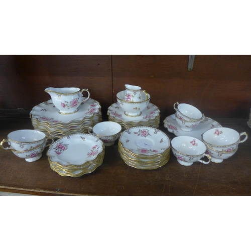 691 - Royal Crown Derby Royal Pinxton Roses tea and dinnerwares, eight setting with cream, sugar and bread... 