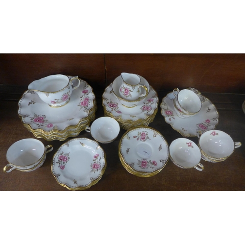 691 - Royal Crown Derby Royal Pinxton Roses tea and dinnerwares, eight setting with cream, sugar and bread... 