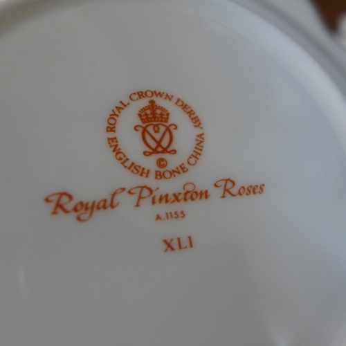 691 - Royal Crown Derby Royal Pinxton Roses tea and dinnerwares, eight setting with cream, sugar and bread... 