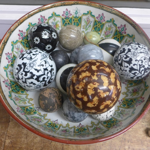 766 - A 19th Century large ceramic bowl with a collection of carved agate and other ceramic balls