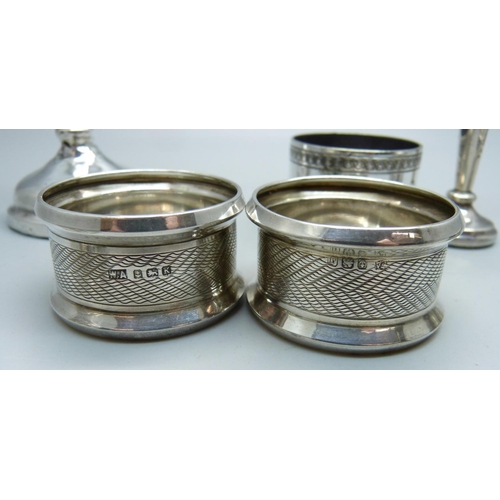 819 - Two silver vases, a pair of silver napkin rings and three other napkin rings