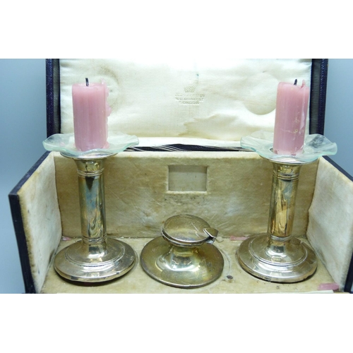 850 - Asprey of London silver candlesticks, inkwell, dip pen and pencil, cased