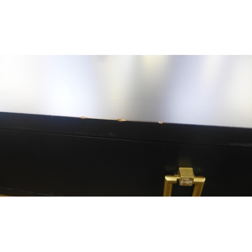 1416 - A black two drawer console table with gold legs, slight damage