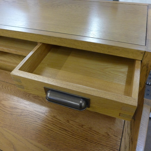 1323 - An oak eight drawer campaign desk