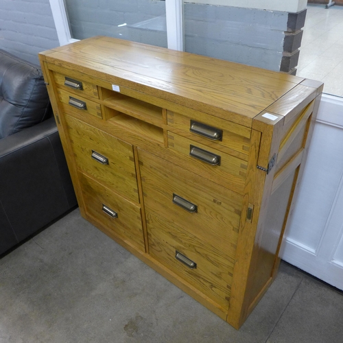 1323 - An oak eight drawer campaign desk