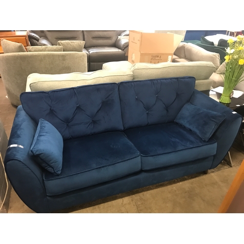 1374 - A blue velvet three seater sofa