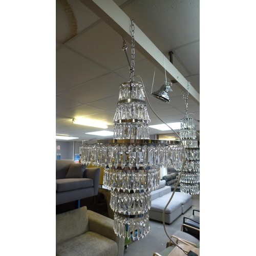 1515A - A glass three tier crystal chandelier, missing some droplets