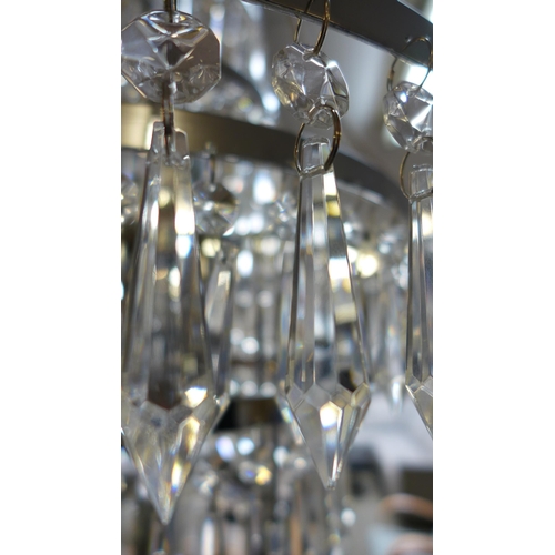 1515A - A glass three tier crystal chandelier, missing some droplets