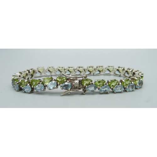 1066 - A silver, topaz and peridot bracelet