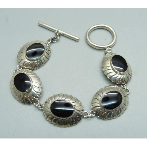 1069 - A silver bracelet with T-bar fastener and black stones