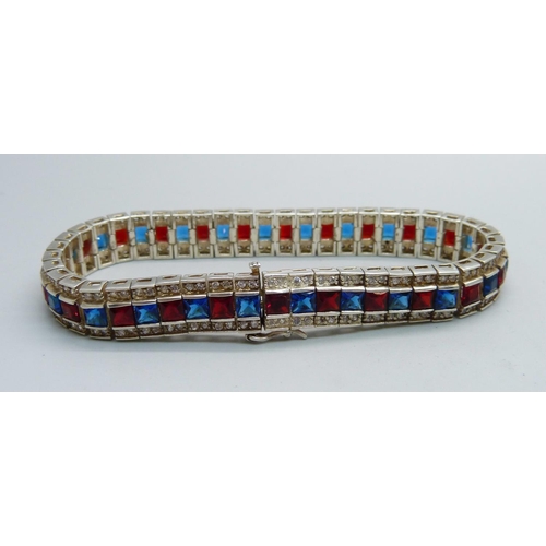 1073 - A silver white, red and blue stone bracelet