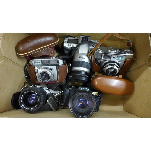 1099 - Five 35mm film cameras including Olympus OM-1 and Pentax **PLEASE NOTE THIS LOT IS NOT ELIGIBLE FOR ... 