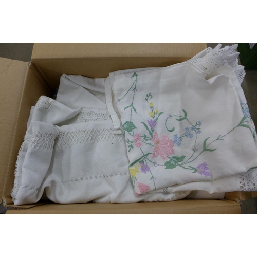 1130 - A box of assorted linen, table cloths, etc.