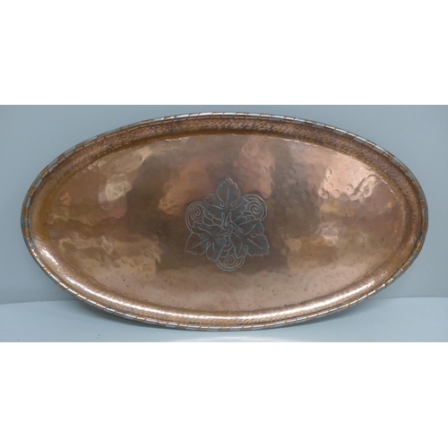 606 - A Hugh Wallis oval copper tray, 43cm