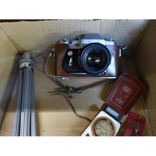 649 - A Zenit camera, cased, with tripod and light meter