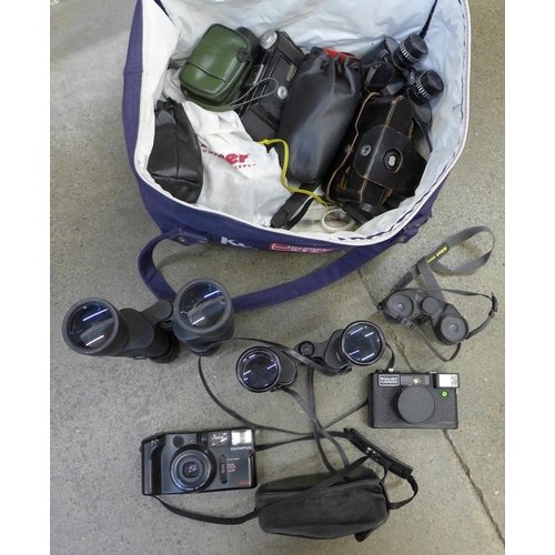 708 - A bag of vintage cameras and binoculars, including Nikon and Olympus