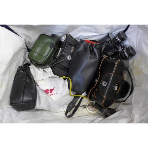 708 - A bag of vintage cameras and binoculars, including Nikon and Olympus