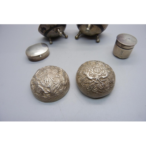 820 - Two silver boxes, one with screw top, two white metal salts with Nile scene decoration and a white m... 