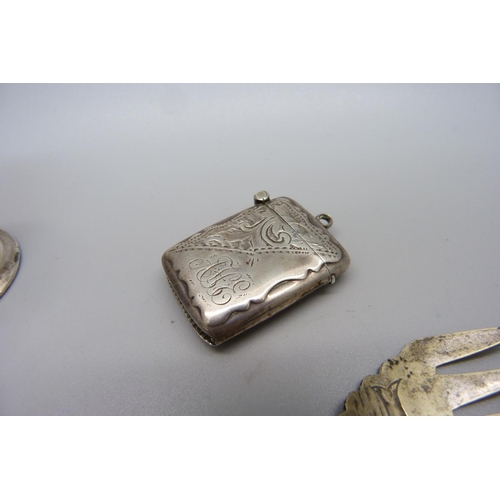 839 - A silver vesta case, a Victorian silver pepper and a fork with silver covered handle