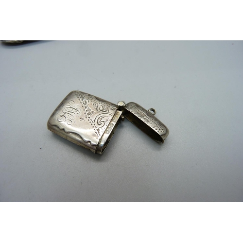 839 - A silver vesta case, a Victorian silver pepper and a fork with silver covered handle