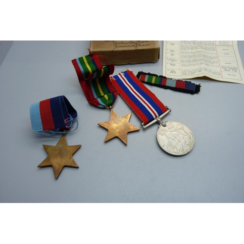 852 - Three WWII medals with ribbons, paper and box addressed to Mr D.L. Barnett, Birmingham