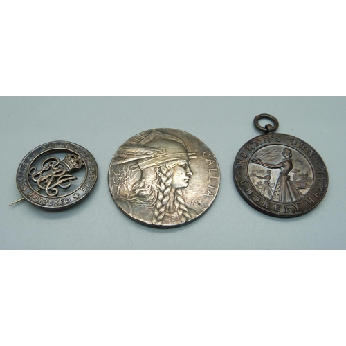 869 - A French white metal medallion, a Woman's Own Cookery medal and a silver wound badge numbered B20484... 