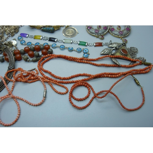 878 - A collection of Eastern white metal jewellery, a coral necklace, etc.