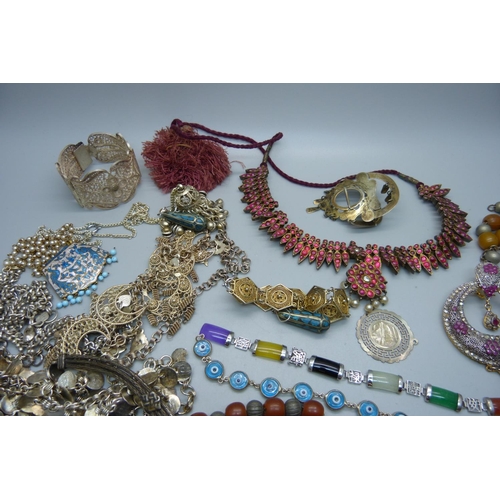 878 - A collection of Eastern white metal jewellery, a coral necklace, etc.