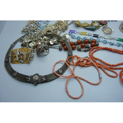 878 - A collection of Eastern white metal jewellery, a coral necklace, etc.