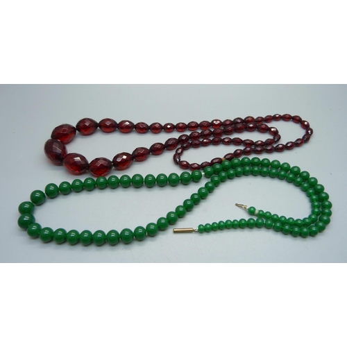 887 - A sherry amber coloured bead necklace and a green bead necklace