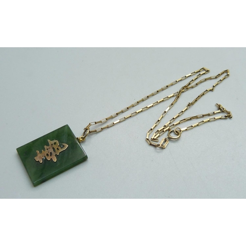 957 - A jade pendant on a 9ct gold chain, (chain 1.9g)