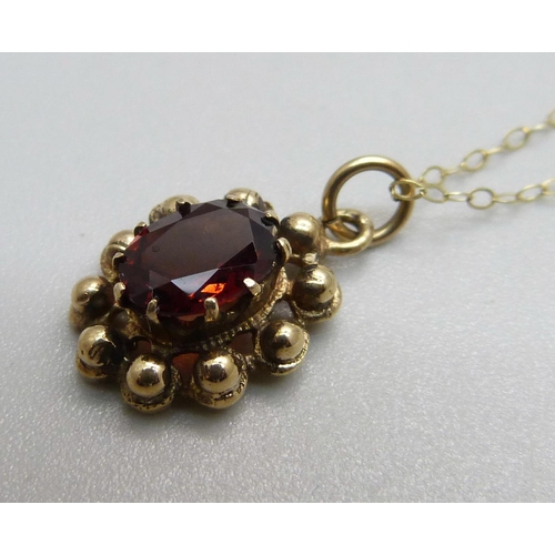 963 - A 9ct gold garnet pendant and fine 9ct gold chain, 2.2g