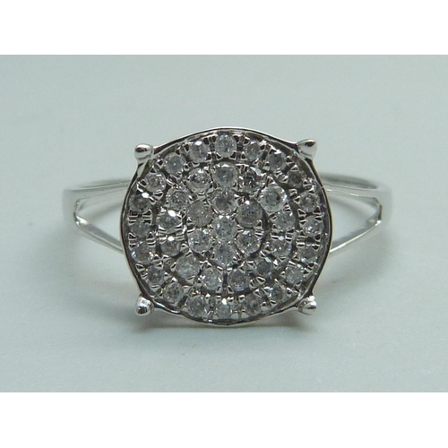 970 - A 9ct white gold forty-stone diamond cluster ring, approximately .50 carat weight, with certificate,... 