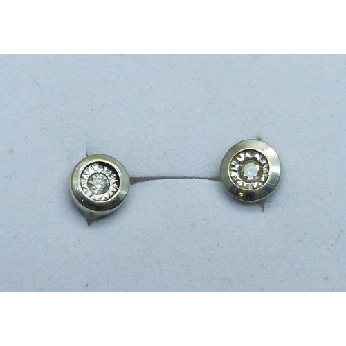 976 - A pair of 9ct white gold diamond ear studs, 1g