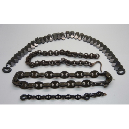 982 - A jet necklaces, two other necklaces and a bracelet, (two require fastening hooks)