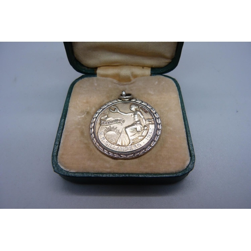 987 - A cased silver Royal Life Saving Society medal, with inscription dated 1932