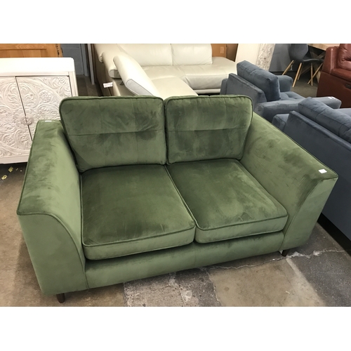 1473 - A moss green velvet two seater sofa