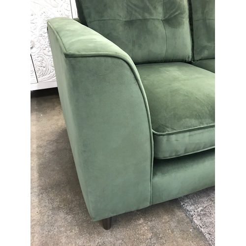 1473 - A moss green velvet two seater sofa