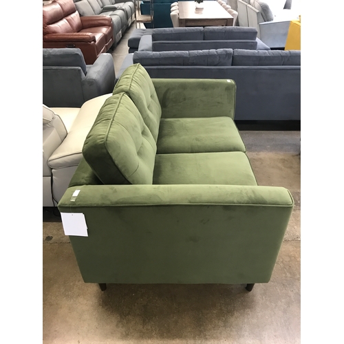 1473 - A moss green velvet two seater sofa