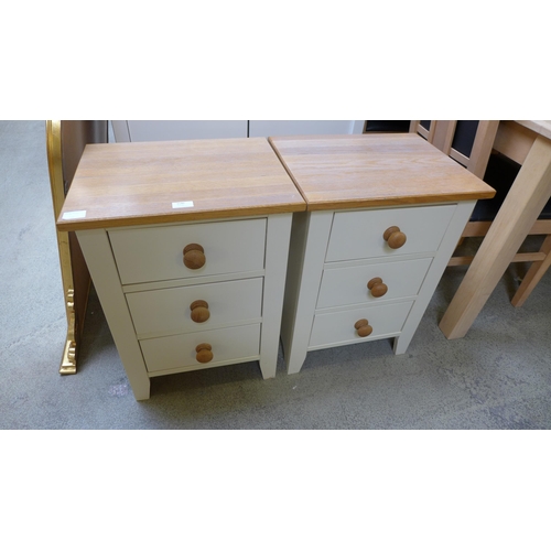 1540 - A pair of cream painted and oak, three drawer bedside chests