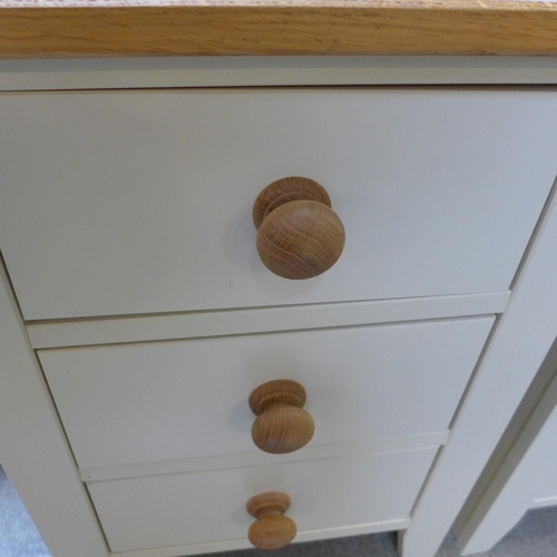 1540 - A pair of cream painted and oak, three drawer bedside chests