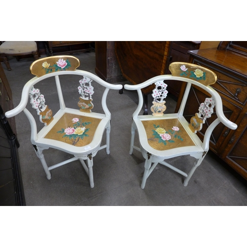 107 - A pair of Chinese cream and gold lacquered chinoiserie corner chairs