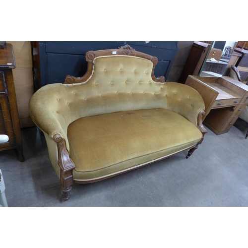 109 - A Victorian carved walnut and fabric upholstered settee