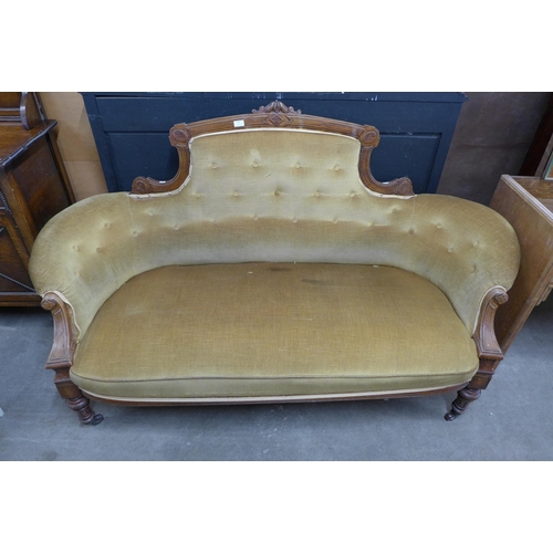 109 - A Victorian carved walnut and fabric upholstered settee